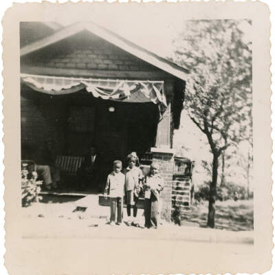 Family in Front of Brick Home