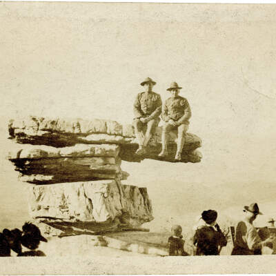 2021.007.002: Two uniformed service members sitting on Umbrella Rock