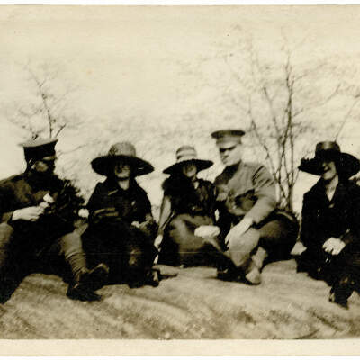 2021.007.003: Two uniformed servicemen sitting with three women
