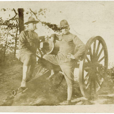 2021.007.004: Two uniformed servicemen posing with a cannon