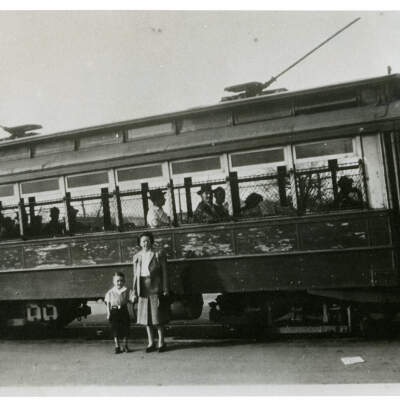 2021.003.007 Woman and child in front of trolley