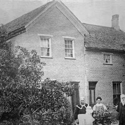Old pioneer home and family