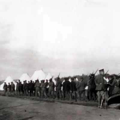Photo of soldiers marching at a camp