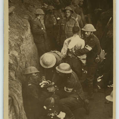 Medic Patching up a Soldiers in a Trench