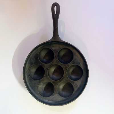 Cast-iron Skillet with seven circular indentations, prior 1997
