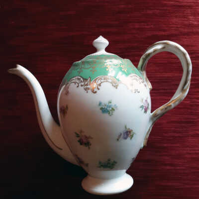 White pedestal-base teapot with design of flowers and rope handle, c. early 1900s