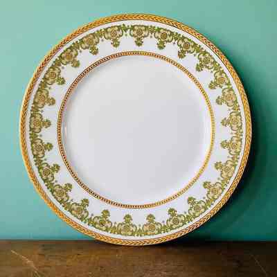White Limoges serving plate with green and gold pattern and gold raised leaf rim