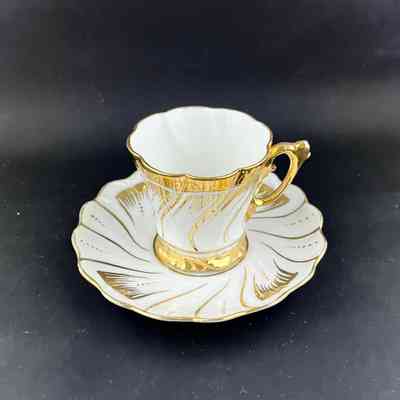 White Porcelain Demitasse cup and saucer with gold designs, 1890s - early 1900s