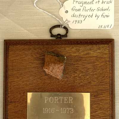Hanging plaque with brick fragment of Porter School, 1973