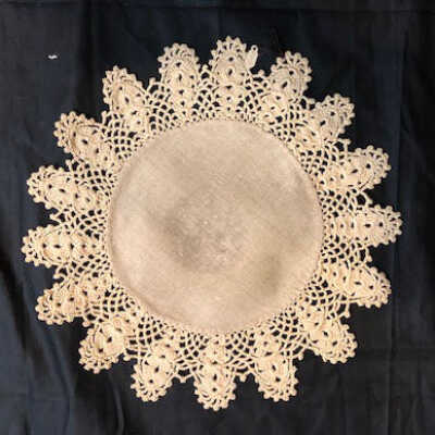 Circular unbleached linen doily with ecru hand crocheted ace edging, c. 1920s