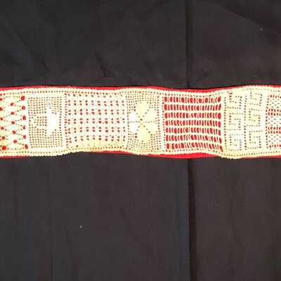 Hand crocheted ecru sash on red background of the Smith family, before 1998