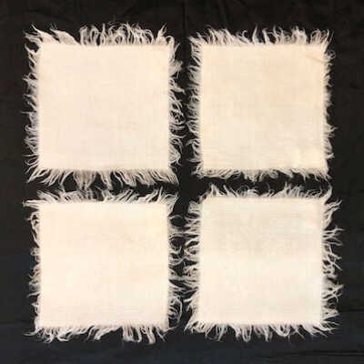 Damask doilies with fringe and embroidery in daisy pattern with greek key border, c. 1905
