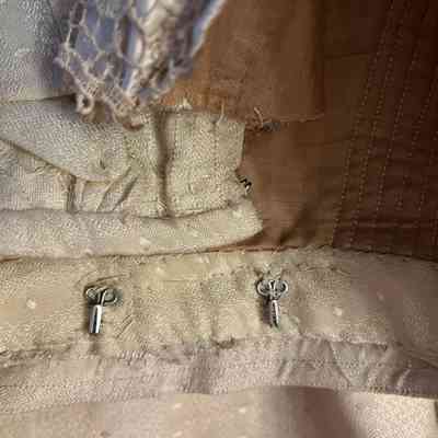 hooks at bottom back. For jabot?