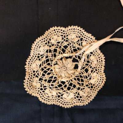 Circular hand-crocheted ecru doily with drawstring ribbon of the Ekberg family, early 1900s