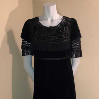 Empire style black velvet gown with black silk fringe, c. 1910