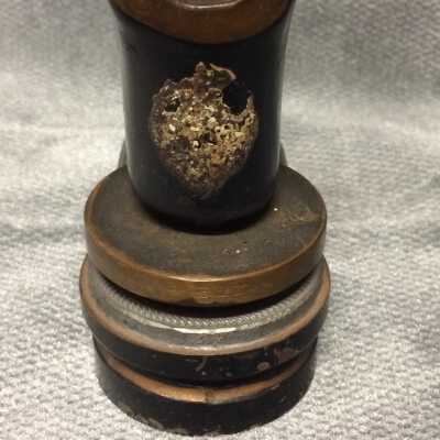 Possible remnants of a manufacturer’s shield-shaped label.