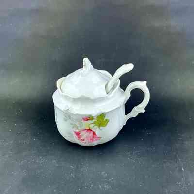 White porcelain mustard pot and spoon with red flower transfers, early 1900s