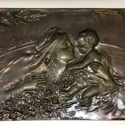 Decorative metal plaque with woman and child, prior 2015