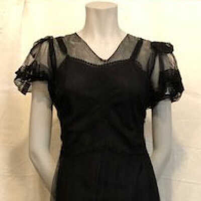 Evening dress of black netting with applique colored flowers, c. 1940s