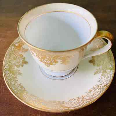 Ivory Noritake china demitasse cup and sauder with raised work, c. 1950s