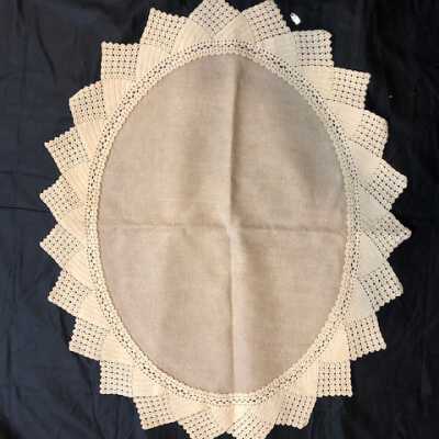 Oval unbleached linen doily with hand crocheted ecru lace edging, c. 1920s
