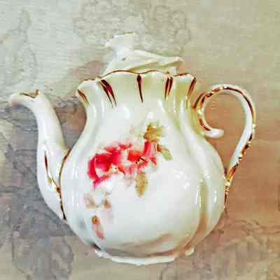 Miniature porcelain teapot with rose flowers and pale green background, c. 1900