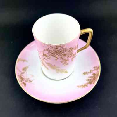 A K Limoges porcelain demitasse cup and saucer with gold flowers on pink, c. early 1900s