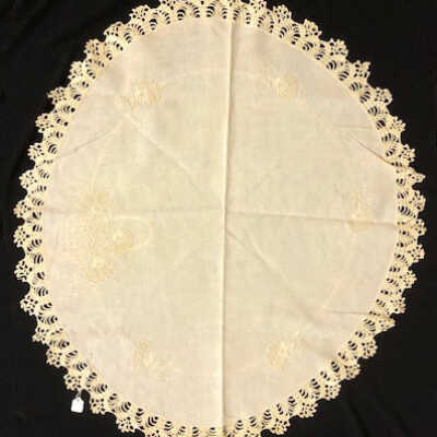 Circular ecru linen tablecloth with embroidered baskets of flowers, c. 1920