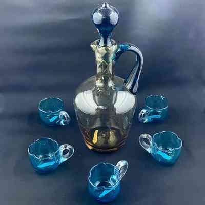Liquor Set of amber bottle with blue stopper, and blue mugs, early 1900s