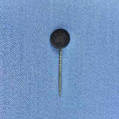 Stick pin attached to a silver coin of the Toye family, c. 1889