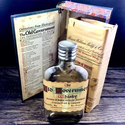 Old Government Whisky flask and book-shaped box, c. 1930s