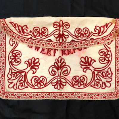 White linen nightgown case with red and white designs, early 1900s
