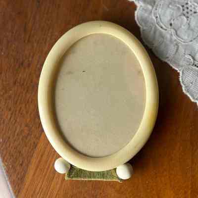 Oval Celluloid picture frame with green velvet backing, c. 1915-1920