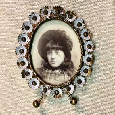Framed oval photo of a girl with bonnet, bu E. Graybill, c. 1890