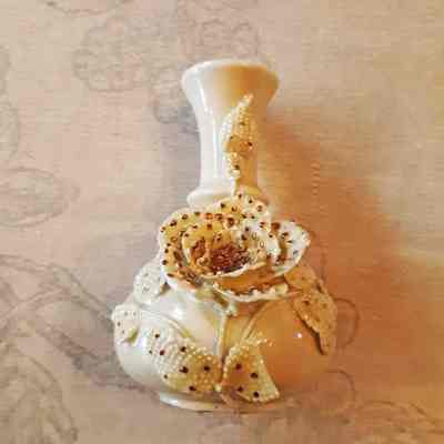 Iridescent green porcelain bud vase with applied flower and leaves, 1890s
