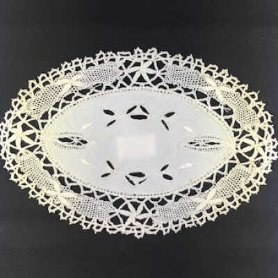 Oval doily with white linen center with open work embroidery