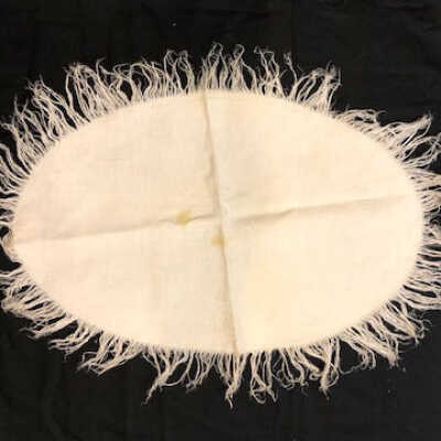 White linen oval damask doily with fern pattern and fringe, early 1900s
