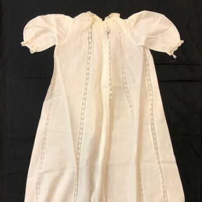 Full length white cotton baby dress with machine lace inserts, c. 1900
