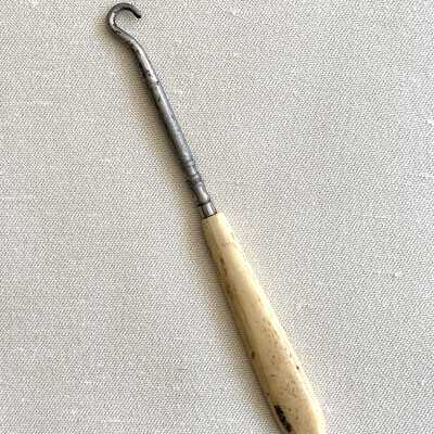 Nickel plated iron button hook with celluloid handle, c. 1912-1915