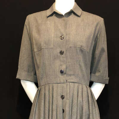 Grey tailored dress with full pleated skirt and breast pockets, c. 1950s