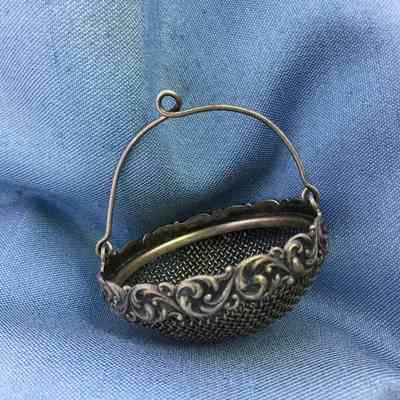 Circular silver tea strainer of the Macdonald family