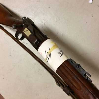 Mysterious paper around rifle.