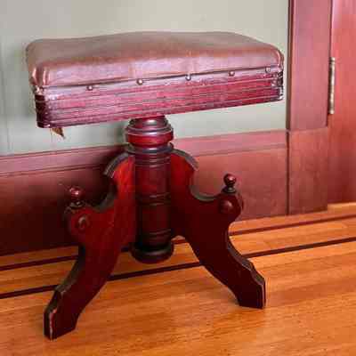 Eastlake-style piano stool with three legs and leatherette upholstery, c. 1880s