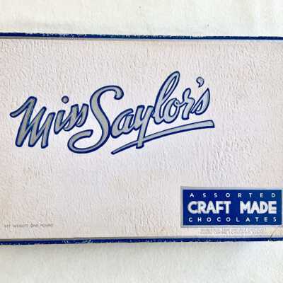 Miss Saylor's candy box with blue, white, and silver design, c. 1938