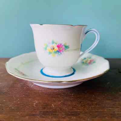 Noritake China cup and saucer with blue interior and painted flowers, c. 1950s