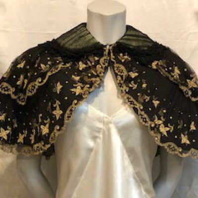 Black chiffon cape with ecru embroidery and green lining, 1900