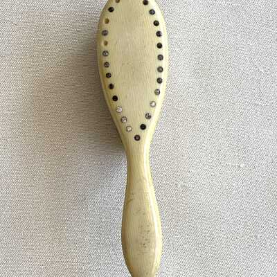 Celluloid handled baby hair brush with rhinestones, c. 1917