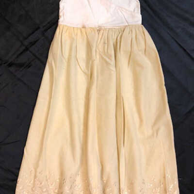 High-waisted pale yellow wool baby slip with acorns, c. 1900-1920