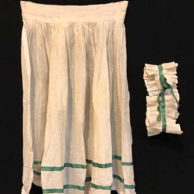 White apron trimmed with green ribbon of the Hoffman family, c. 1940s