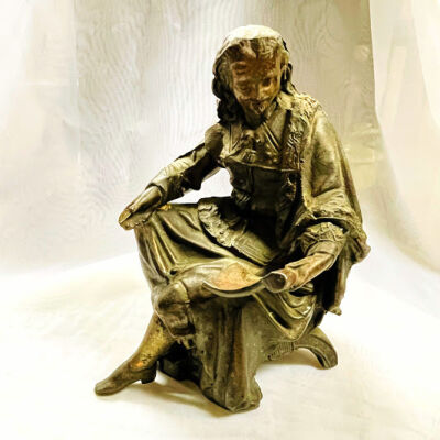 Metal figurine of a seated man in 16th Century dress, c. 1890s